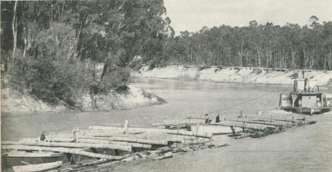 Logs chained to the outriggers on a barge 'train', Echuca, 1950