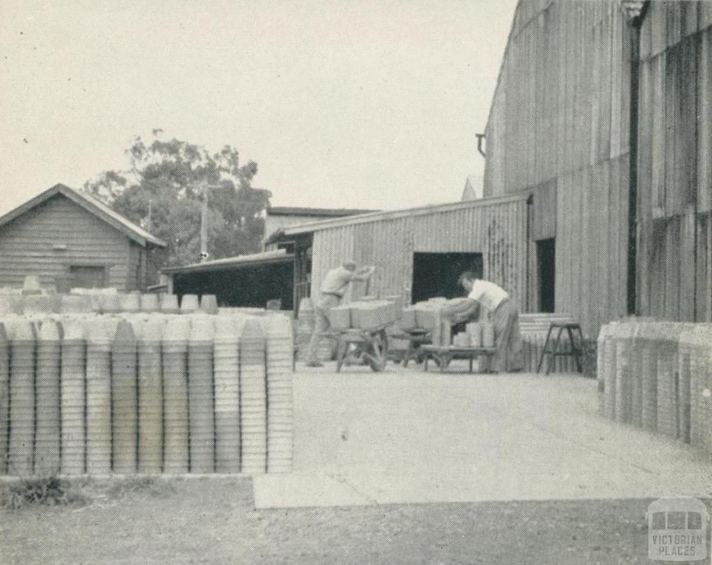 Stacking pots ready for firing, Nunawading, 1956