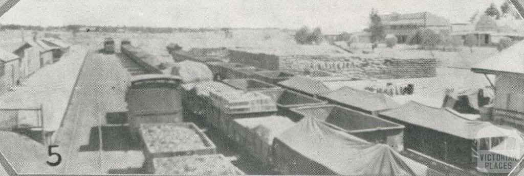 Wheat trucks and stack at Ouyen, 1927